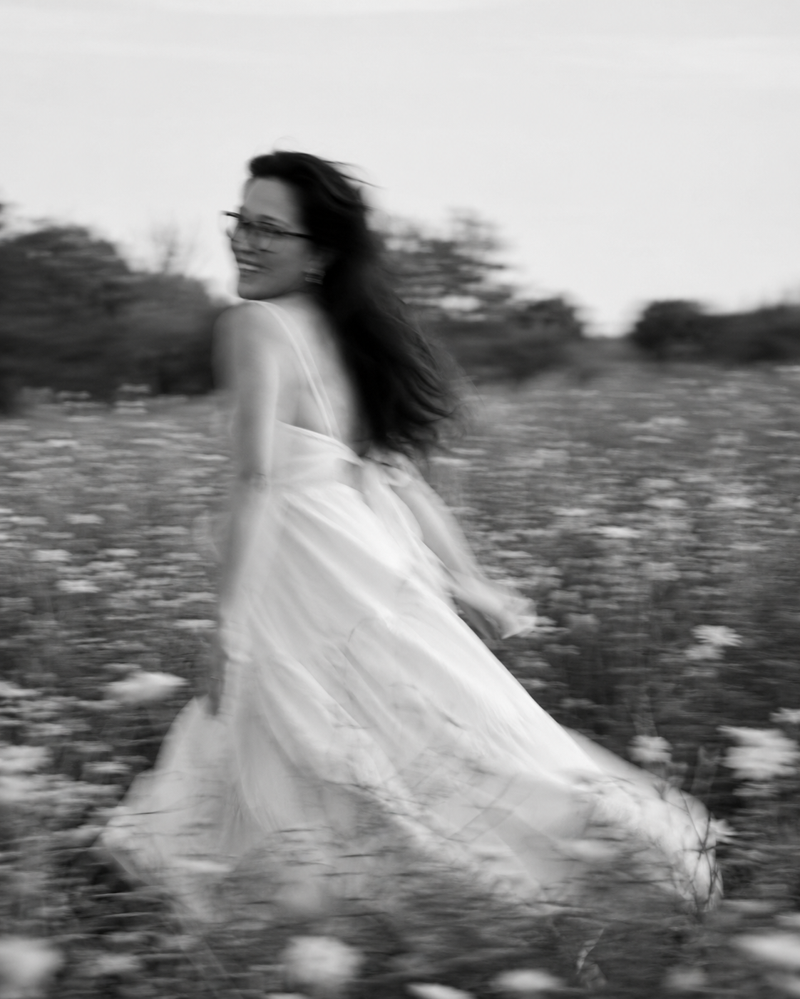 Woman running through a flower field